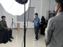 Demonstrating lighting techniques in Basic Photography course.